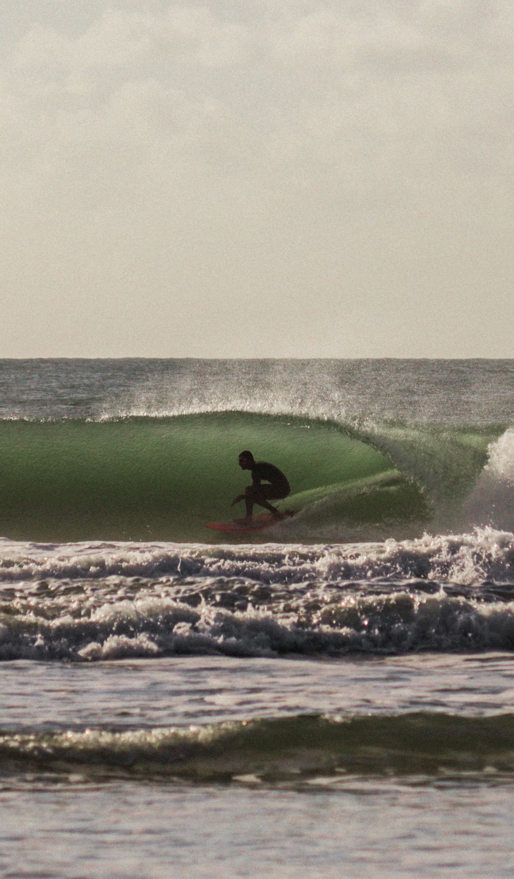 A surfer riding an Atlantic wave in Morocco